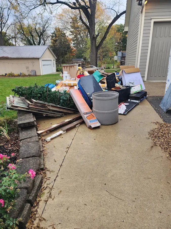 Dumpster being loaded with debris for Estate Cleanout Dumpster Rental in West Tisbury